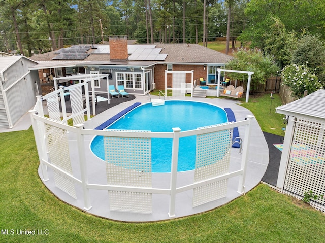 view of pool with a patio, a yard, and a wooden deck