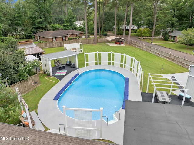 view of swimming pool with a patio and a lawn