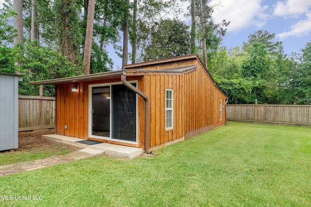 view of outbuilding with a yard