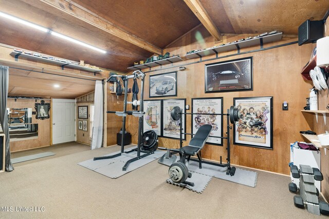 workout room featuring lofted ceiling, wooden walls, and light colored carpet