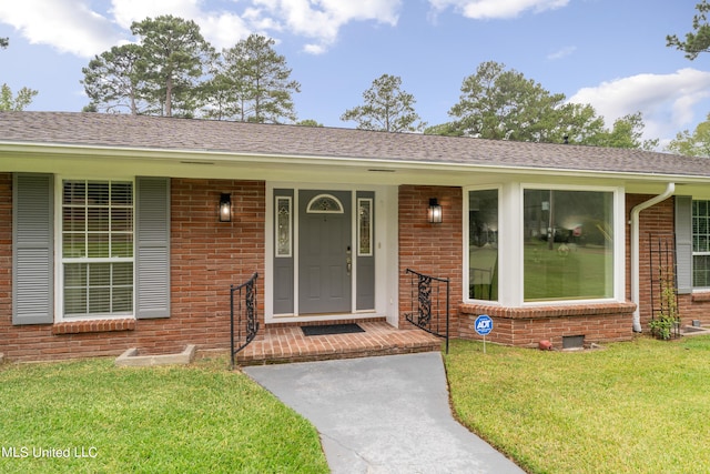 doorway to property with a yard and a porch