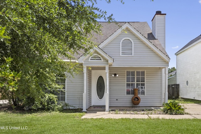 2383 Trafalgar Dr, Biloxi, MS 39531 - view of front facade with a front lawn, a chimney, and roof with shingles