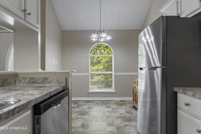 2383 Trafalgar Dr, Biloxi, MS 39531 - kitchen featuring stainless steel appliances, vaulted ceiling, white cabinets, a chandelier, and pendant lighting