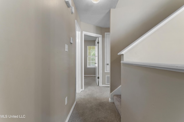 2383 Trafalgar Dr, Biloxi, MS 39531 - corridor featuring carpet floors, a textured ceiling, and stairway