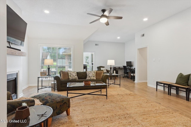 4275 Bienville Rd, Nesbit, MS 38651 - living area featuring wood finished floors, a fireplace, a ceiling fan, baseboards, and recessed lighting