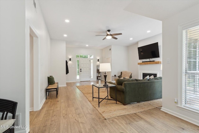 4275 Bienville Rd, Nesbit, MS 38651 - living room with light wood-style floors, a fireplace, ceiling fan, baseboards, and recessed lighting