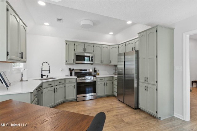 4275 Bienville Rd, Nesbit, MS 38651 - kitchen with stainless steel appliances, a sink, light wood-style floors, recessed lighting, and light countertops