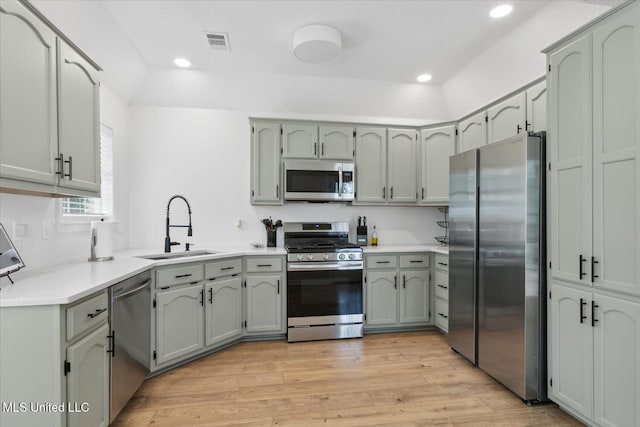 4275 Bienville Rd, Nesbit, MS 38651 - kitchen featuring appliances with stainless steel finishes, a sink, light wood-type flooring, light countertops, and recessed lighting