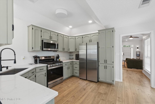 4275 Bienville Rd, Nesbit, MS 38651 - kitchen featuring appliances with stainless steel finishes, a sink, light wood-style floors, recessed lighting, and a ceiling fan