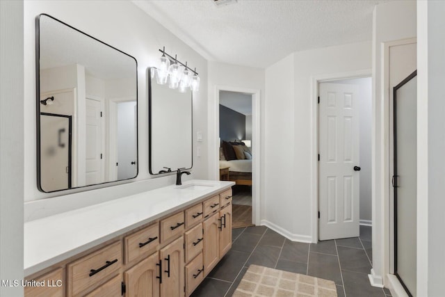 4275 Bienville Rd, Nesbit, MS 38651 - full bathroom with vanity, ensuite bath, a textured ceiling, a shower stall, and tile patterned floors