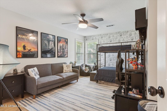 4275 Bienville Rd, Nesbit, MS 38651 - bedroom featuring wood finished floors, a textured ceiling, and a ceiling fan