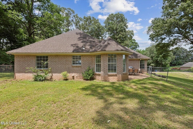 4275 Bienville Rd, Nesbit, MS 38651 - back of house featuring a shingled roof, a patio area, and brick siding