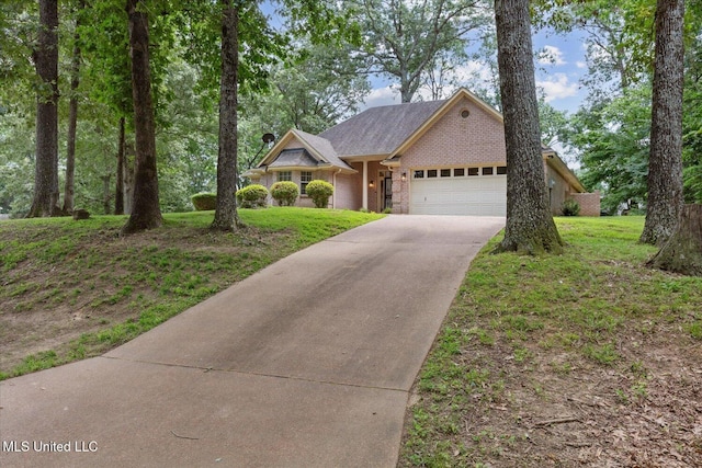 4275 Bienville Rd, Nesbit, MS 38651 - view of front of property with an attached garage, driveway, a front lawn, and brick siding