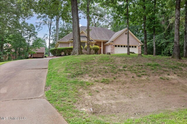 4275 Bienville Rd, Nesbit, MS 38651 - view of front facade featuring a garage and brick siding