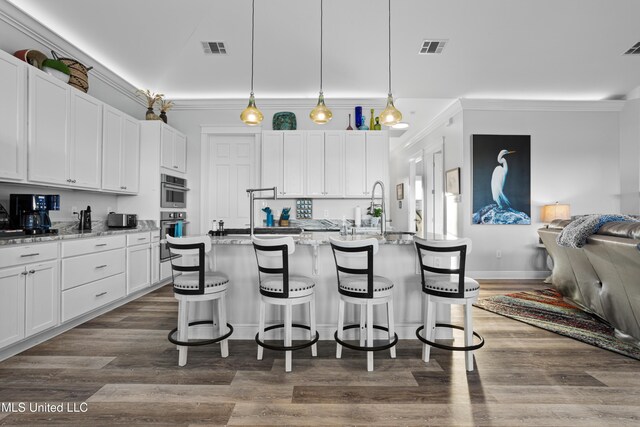 14 Sherman Ave, Pass Christian, MS 39571 - kitchen featuring a breakfast bar area, visible vents, and white cabinetry