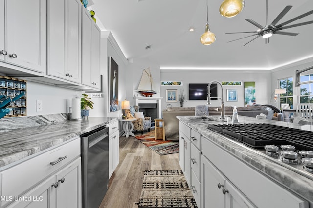 14 Sherman Ave, Pass Christian, MS 39571 - kitchen featuring lofted ceiling, a fireplace, light wood-style flooring, open floor plan, and appliances with stainless steel finishes