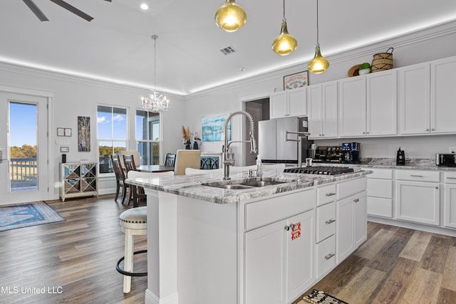 14 Sherman Ave, Pass Christian, MS 39571 - kitchen with a sink, a kitchen island with sink, a breakfast bar area, light stone countertops, and appliances with stainless steel finishes