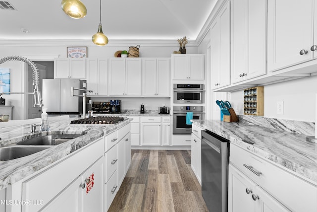 14 Sherman Ave, Pass Christian, MS 39571 - kitchen featuring visible vents, a sink, wood finished floors, stainless steel appliances, and white cabinets