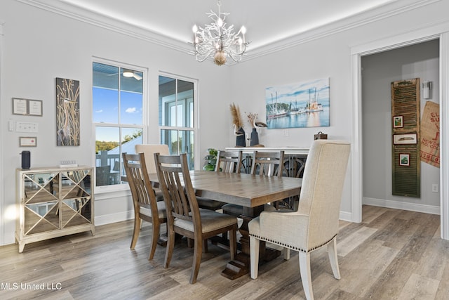 14 Sherman Ave, Pass Christian, MS 39571 - dining room with ornamental molding, a notable chandelier, baseboards, and light wood-style floors