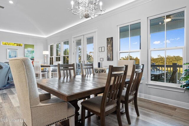 14 Sherman Ave, Pass Christian, MS 39571 - dining space featuring vaulted ceiling, a notable chandelier, baseboards, ornamental molding, and wood finished floors