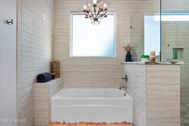 14 Sherman Ave, Pass Christian, MS 39571 - bathroom with an inviting chandelier, a bath, and a tile shower