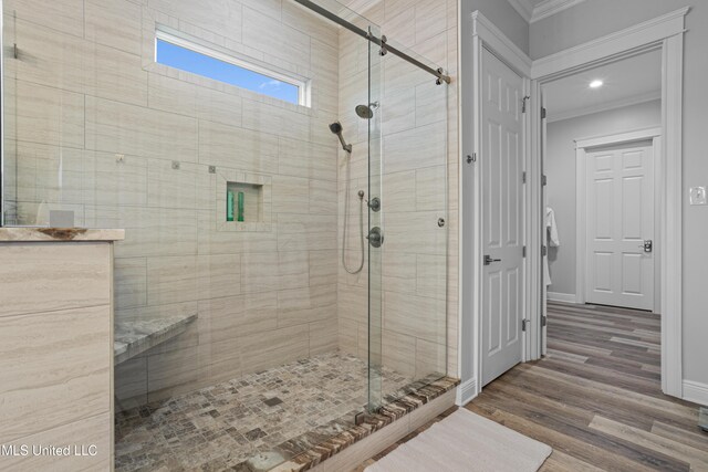 14 Sherman Ave, Pass Christian, MS 39571 - full bathroom featuring a stall shower, ornamental molding, baseboards, and wood finished floors