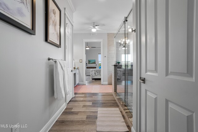 14 Sherman Ave, Pass Christian, MS 39571 - interior space with ceiling fan with notable chandelier, wood finished floors, ornamental molding, ensuite bath, and baseboards