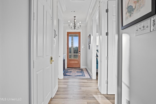 14 Sherman Ave, Pass Christian, MS 39571 - doorway to outside featuring light wood finished floors, an inviting chandelier, visible vents, baseboards, and ornamental molding