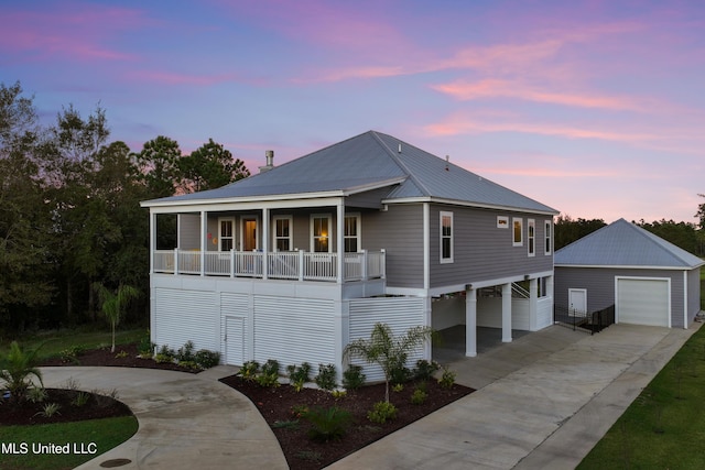 14 Sherman Ave, Pass Christian, MS 39571 - raised beach house with a porch, driveway, a garage, an outbuilding, and metal roof