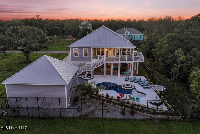 14 Sherman Ave, Pass Christian, MS 39571 - back of house with stairway, metal roof, a fenced backyard, and an outdoor living space