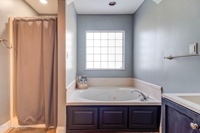 bathroom with a bath and vanity