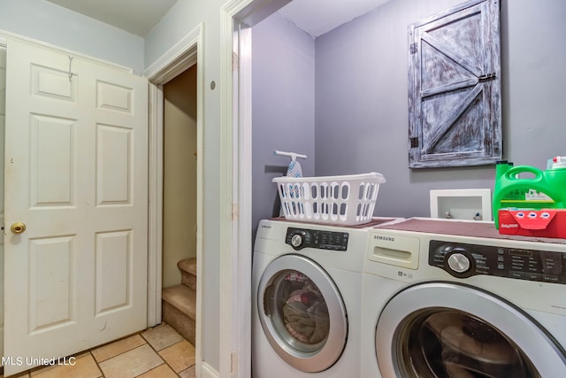 washroom with light tile patterned flooring and washer and clothes dryer