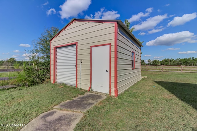 view of outbuilding featuring a garage and a lawn