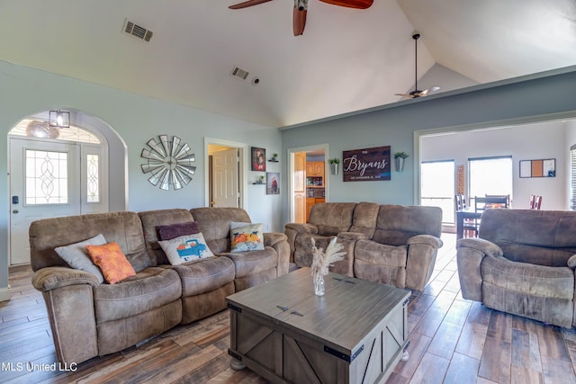 living room with hardwood / wood-style flooring, high vaulted ceiling, and ceiling fan