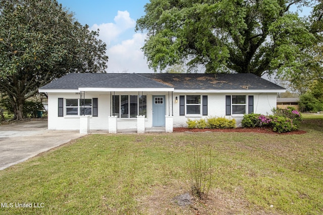 ranch-style home with a front lawn