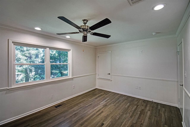 empty room featuring ornamental molding, dark wood-type flooring, and ceiling fan