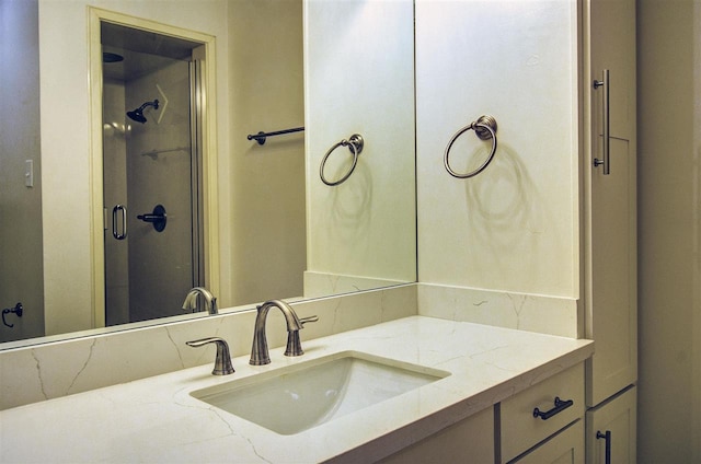 bathroom featuring vanity and an enclosed shower