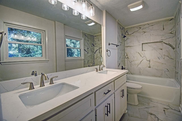 full bathroom with a textured ceiling, toilet, tiled shower / bath, vanity, and ornamental molding