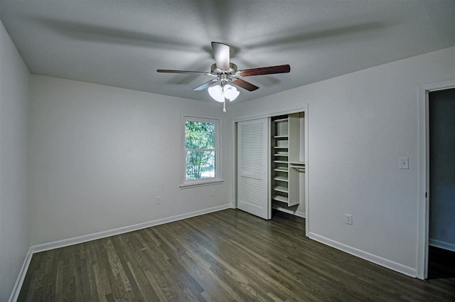 unfurnished bedroom with a closet, dark hardwood / wood-style floors, a textured ceiling, and ceiling fan