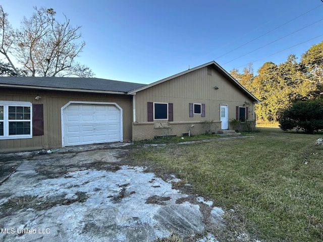 view of front of property with a front yard and a garage