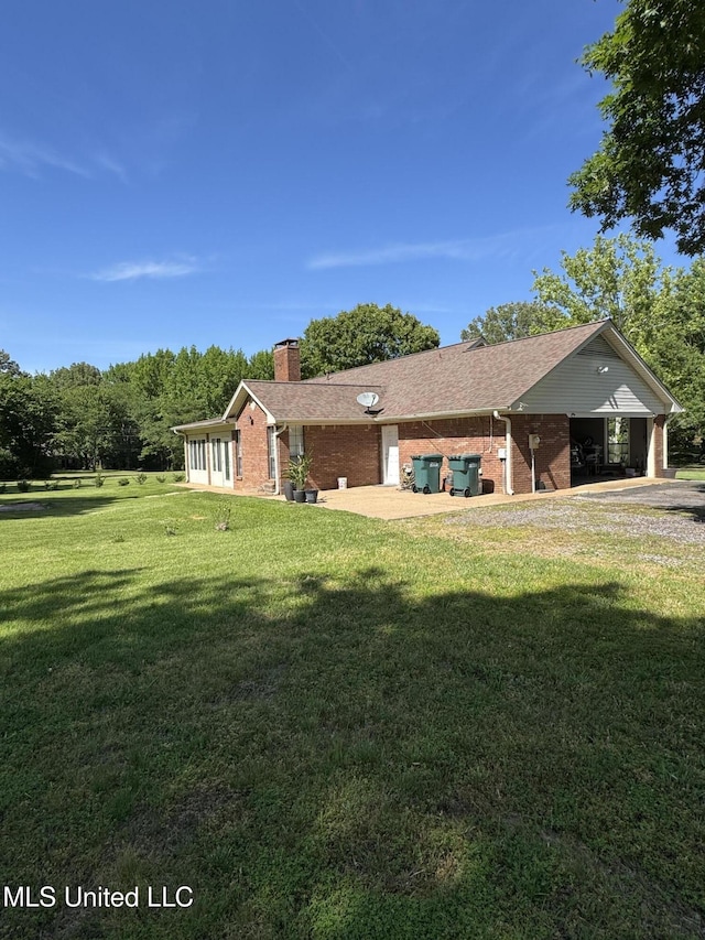 5205 Marthavale Cv, Southaven, MS 38671 - rear view of property featuring a chimney, brick siding, and a lawn