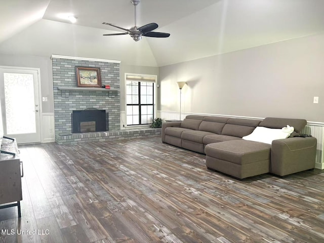 5205 Marthavale Cv, Southaven, MS 38671 - living area with vaulted ceiling, wood finished floors, a wainscoted wall, ceiling fan, and a brick fireplace