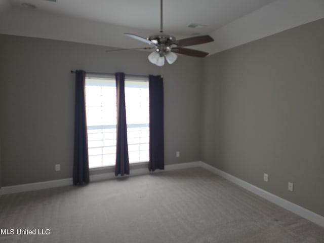 empty room featuring ceiling fan, baseboards, and carpet