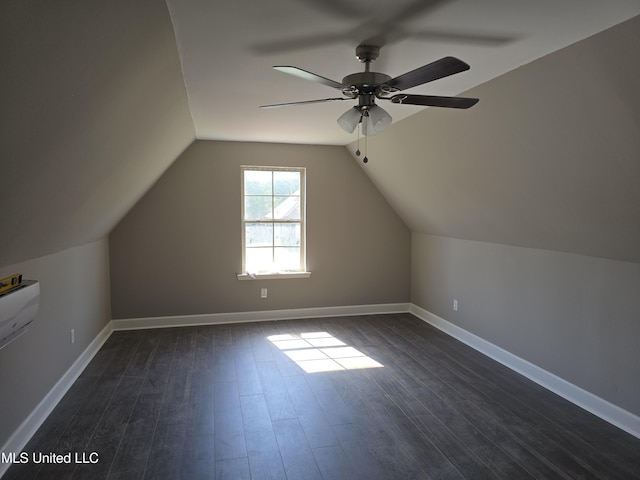 bonus room with baseboards, ceiling fan, dark wood finished floors, and lofted ceiling