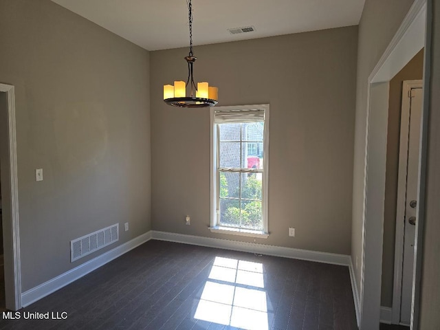 unfurnished dining area featuring visible vents, baseboards, dark wood-style flooring, and a chandelier