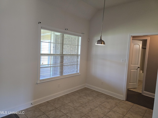 unfurnished dining area featuring baseboards and light tile patterned floors