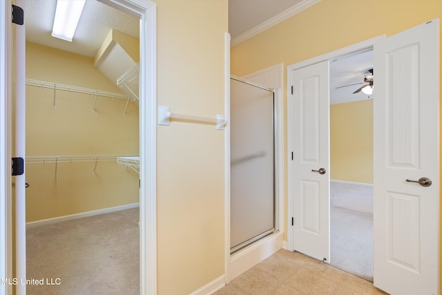 bathroom with crown molding, walk in shower, a textured ceiling, and ceiling fan