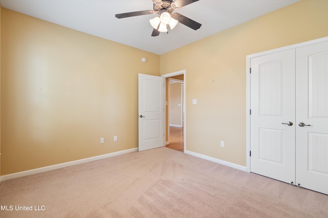 unfurnished bedroom featuring a closet, ceiling fan, and light carpet