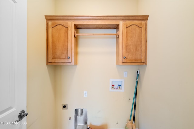 laundry area featuring hookup for an electric dryer, hookup for a washing machine, gas dryer hookup, and cabinets