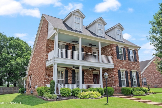 view of front of property featuring a balcony, a front yard, covered porch, and ceiling fan